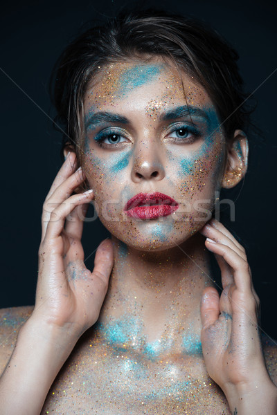 Portrait of beautiful woman with blue sparkles on her face Stock photo © deandrobot