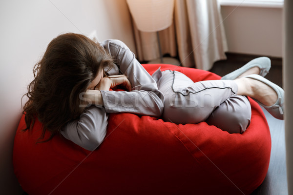 Young woman sleeping on chair bag Stock photo © deandrobot