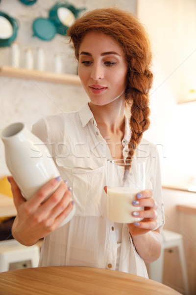 Genç kadın şişe süt Stok fotoğraf © deandrobot