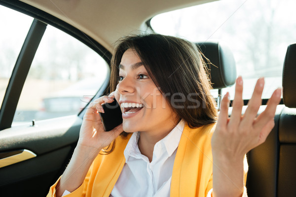 Close up portrait of a young female executive on phone Stock photo © deandrobot