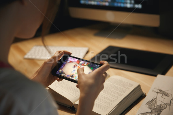 Cropped photo of lady designer play games by mobile phone. Stock photo © deandrobot