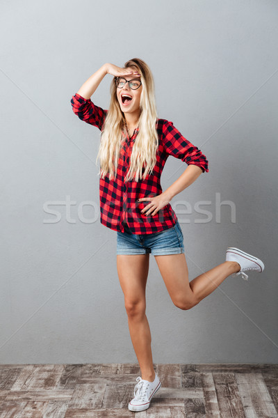 Emotional young blonde woman looking aside. Stock photo © deandrobot