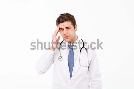 Portrait of a exhausted young male doctor Stock photo © deandrobot