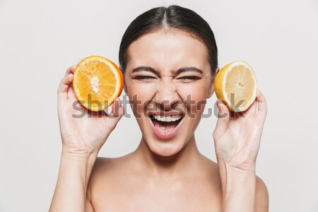Atractivo mujer naranja rebanadas cara Foto stock © deandrobot