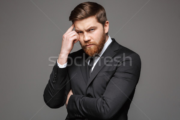 Portré töprengő fiatal üzletember öltöny néz Stock fotó © deandrobot