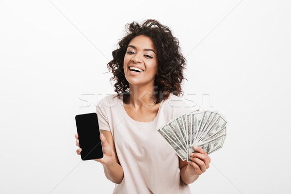 Excited young american woman with afro hairstyle and big smile h Stock photo © deandrobot