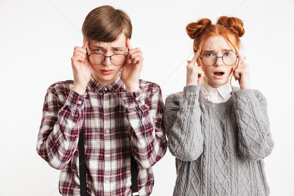 Stock photo: Upset couple of school nerds having headache