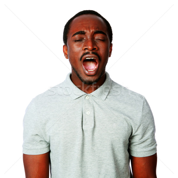 Portrait of african man shouting isolated on white background Stock photo © deandrobot