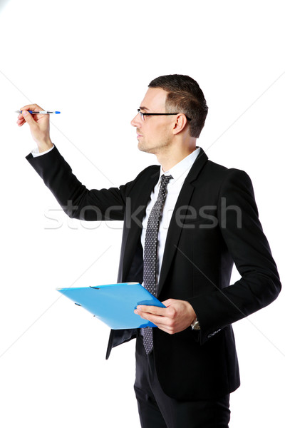 Handsome businessman writes with pen at copyspace over white background Stock photo © deandrobot