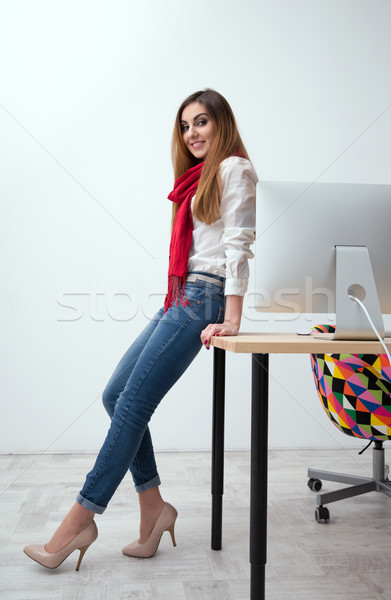 Stock photo: Portrait of a beautiful smiling woman leaning on the table