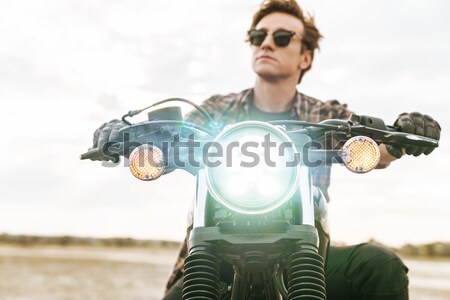 Closeup of a female applying lipstick in mirror motocycle Stock photo © deandrobot