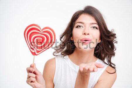 Cute girl covering her eye with lollipop Stock photo © deandrobot