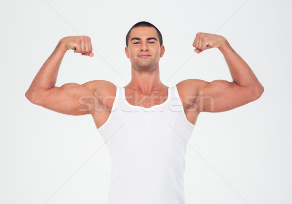 Happy muscular man showing his biceps  Stock photo © deandrobot