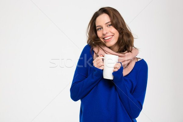 Stock photo: Cheerful attractive woman in warm pink scarf holding white mug 