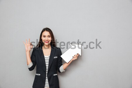 Inspired attractive young woman with long hair standing and dreaming Stock photo © deandrobot