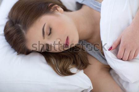 Close-up portrait of a young laughing couple in bed Stock photo © deandrobot