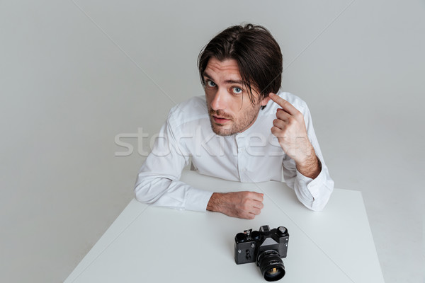 Man pointing at his ear Stock photo © deandrobot