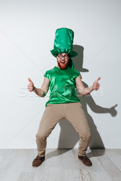 Full length of screaming man in green costume Stock photo © deandrobot