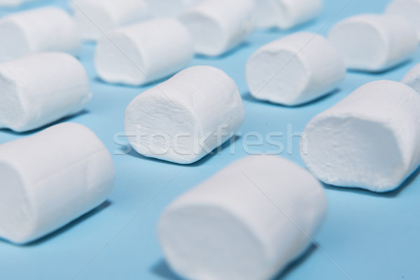 White sweeties marshmallows over blue table background. Stock photo © deandrobot