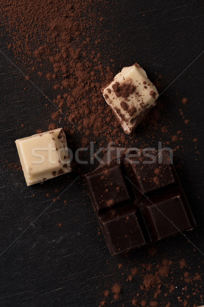 Top view of white and dark crashed chocolate bar tiles Stock photo © deandrobot
