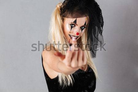 Scary spooky blonde woman dressed in black widow halloween costume Stock photo © deandrobot
