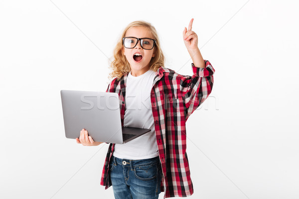 Portrait excité petite fille lunettes ordinateur portable [[stock_photo]] © deandrobot