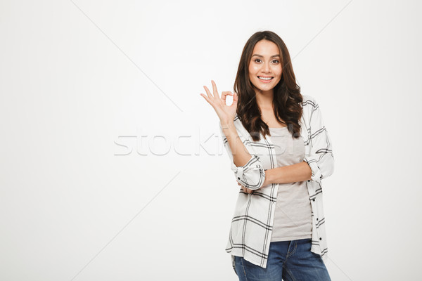 Portrait of optimistic satisfied woman with long brown hair posi Stock photo © deandrobot