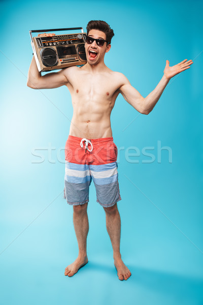 Stock photo: Full length portrait if a cheerful shirtless man