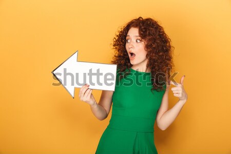 Stock photo: Portrait of a shocked redhead woman in dress