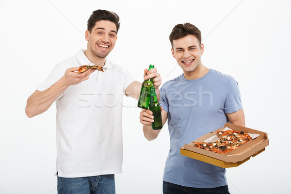 Portrait of two excited young men celebrating Stock photo © deandrobot