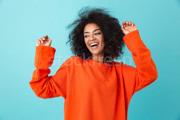 Happy portrait of excited woman in red shirt looking on camera w Stock photo © deandrobot