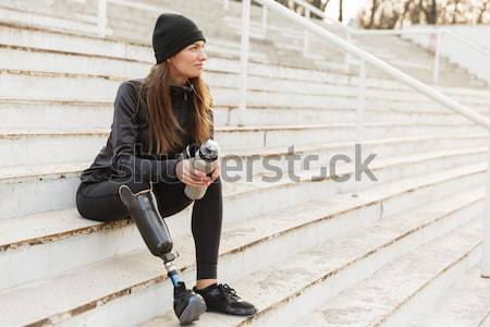 Photo of atlethic disabled woman in sportswear with prosthetic l Stock photo © deandrobot