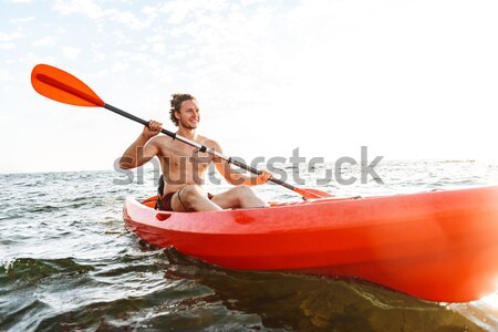 Przystojny mężczyzna kajakarstwo jezioro morza łodzi widok z tyłu Zdjęcia stock © deandrobot