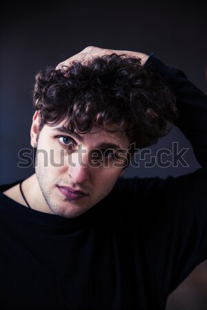 Young handsome man looking at camera  Stock photo © deandrobot