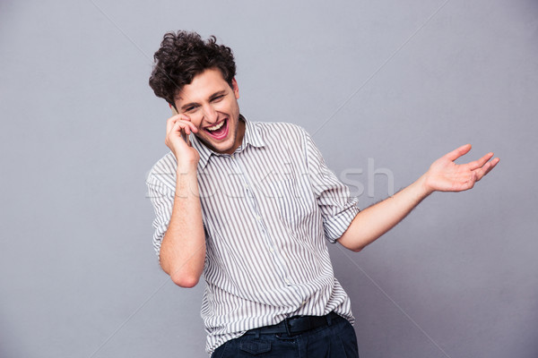 Cheerful man talking on the phone Stock photo © deandrobot