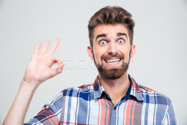 Vicces férfi mutat ok felirat ujjak Stock fotó © deandrobot