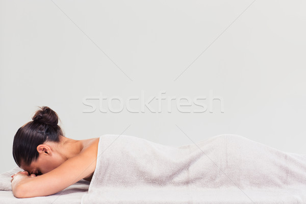 Woman lying on massage lounger Stock photo © deandrobot