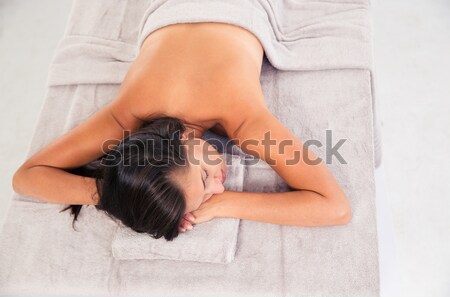 Stock photo: Young woman sleeping on massage lounger