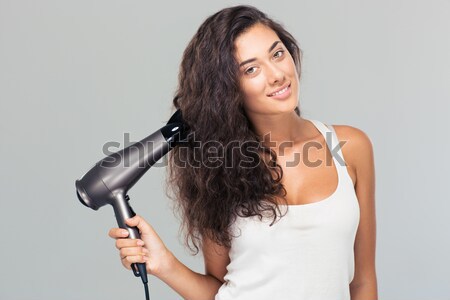 Smiling woman in towel drying her hair Stock photo © deandrobot