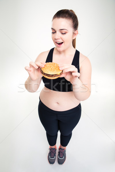 Fat woman eating burger Stock photo © deandrobot