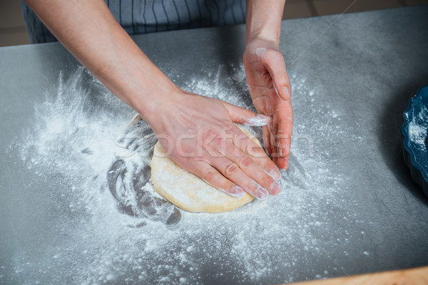 Man hands making dough on the table Stock photo © deandrobot