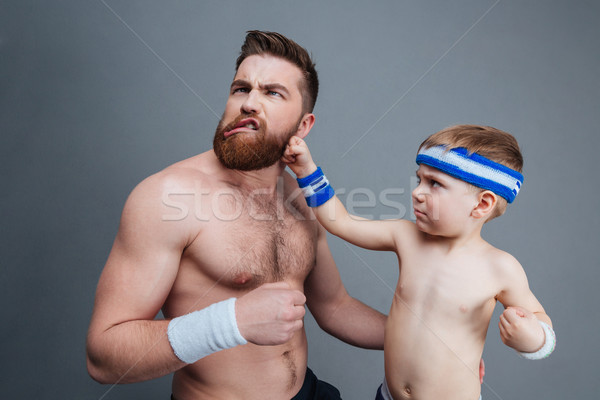 Funny bearded dad and his son fighting Stock photo © deandrobot