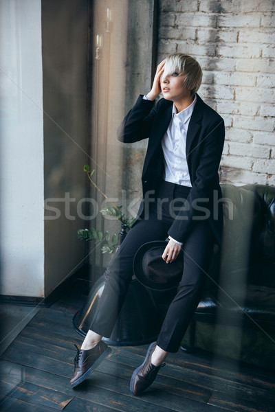 Blonde cute girl looking at something in the window Stock photo © deandrobot