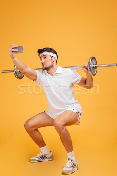 смешные спортсмен штанга говорить смартфон Сток-фото © deandrobot