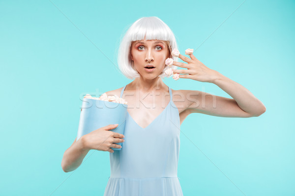 Pretty blonde young woman wih marshmallows on her fingers Stock photo © deandrobot