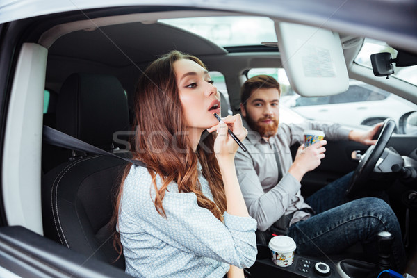 Beauty couple in car with coffee Stock photo © deandrobot