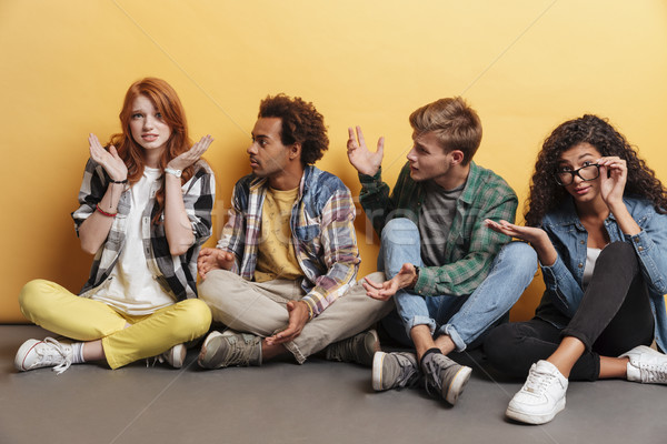 Multiethnic group of friends sitting and blaming unsure embarrassed girl Stock photo © deandrobot