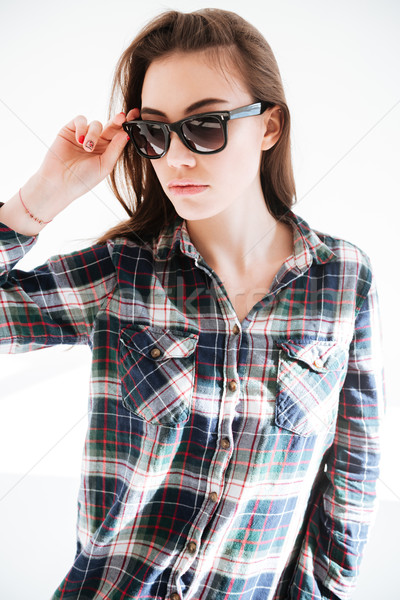 Portrait of beautiful young woman in plaid shirt and sunglasses Stock photo © deandrobot