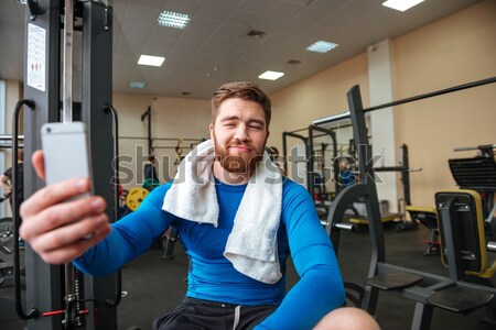 Smiling young sportsman make thumbs up gesture Stock photo © deandrobot