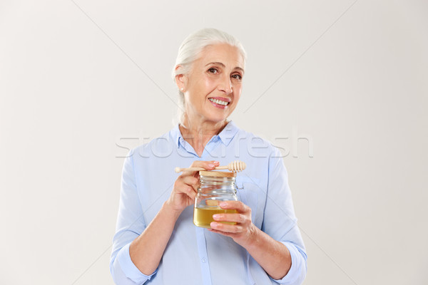 Porträt reife Frau halten Honig Stock foto © deandrobot